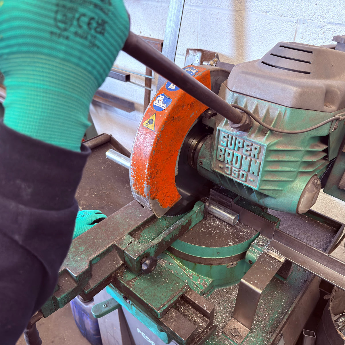A close-up action shot of a person cutting and manufacturing  The Gong Bar